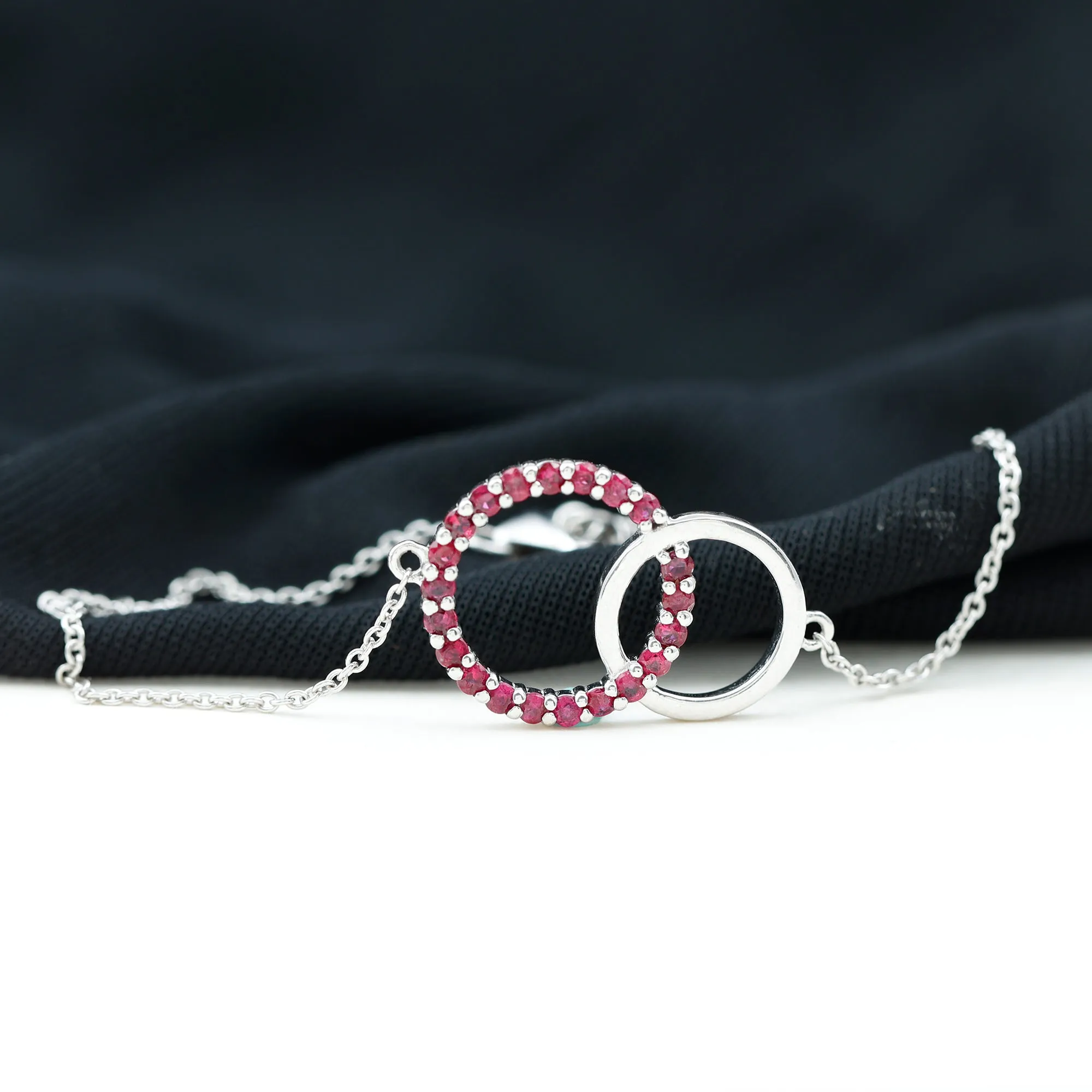 0.75 CT Round Cut Ruby Interlock Chain Eternity Bracelet in Prong Setting