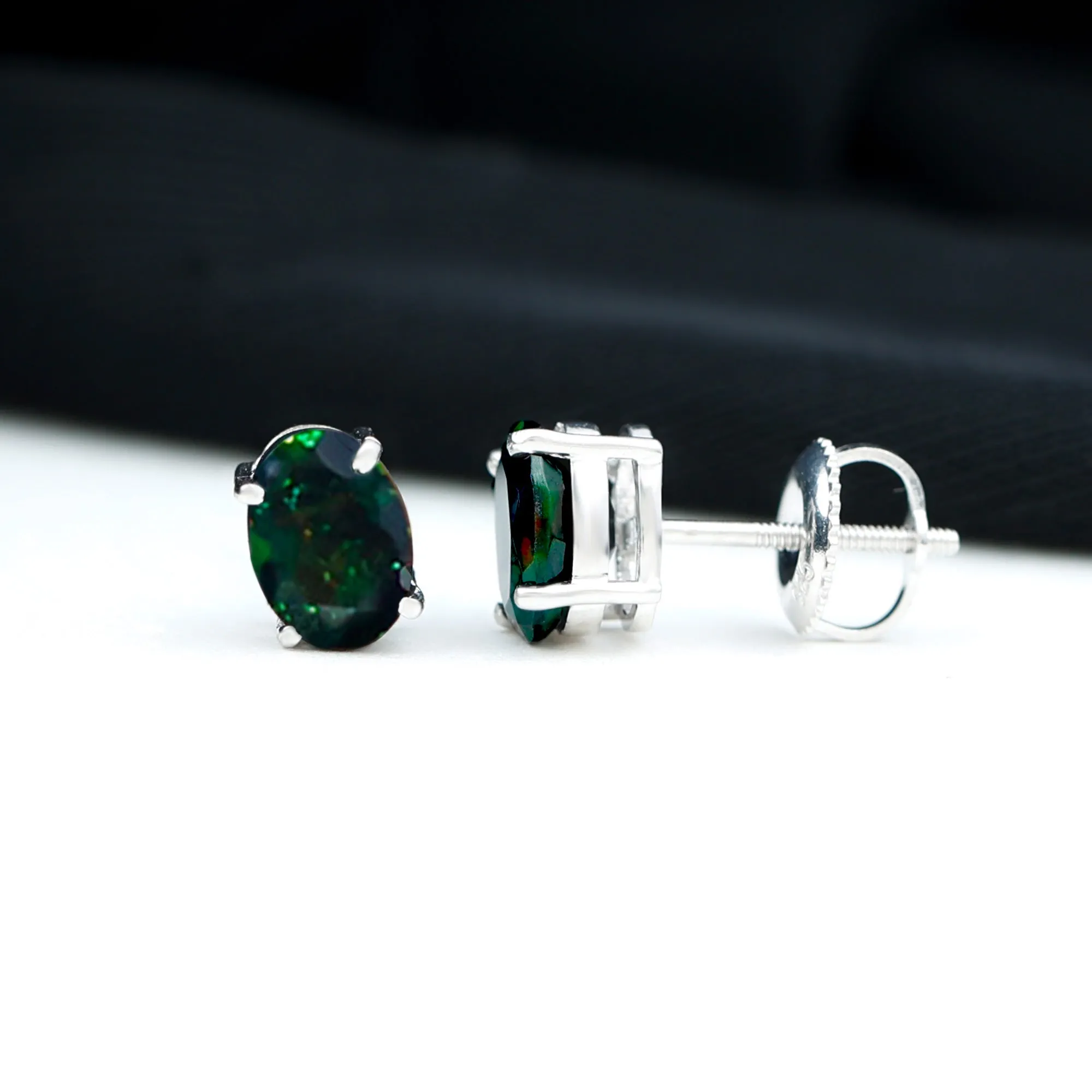 Oval Cut Black Opal Solitaire Stud Earrings in 4 Prong Setting